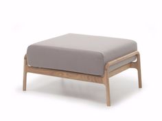 the footstool is made from wood and has a gray cushion on one side