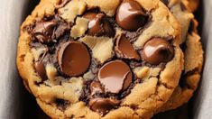 three chocolate chip cookies in a box on a table