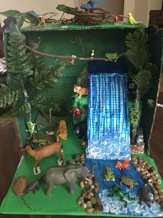 an open cardboard box filled with toy animals and water features on the inside, along with other toys