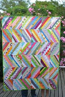 a colorful quilt is hanging on the wall