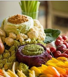 a table topped with lots of different types of vegetables and dips on top of each other