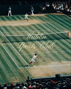 two men playing tennis on a grass court