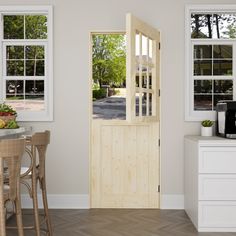 an open wooden door in a white kitchen