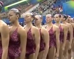 a group of women in bathing suits standing next to each other on a stage at a sporting event