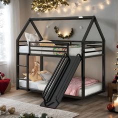 a child's bed with a slide in front of it and christmas decorations on the wall