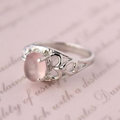 Presenting you A Beautiful Rose Quartz Ring In Filigree  Style Shank Ring with Oval Cabochon Rose Quartz . The color of the cabochon used is really soothing to the eyes. Perfect Gift For Her or as a proposal Ring or you can gift yourself Item No: skj.18.501 Item: Pink Quartz Ring in 925 Sterling Silver Primary Stone: Pink Quartz Secondary Stone:-- Article Weight: 5.1 gms primary stone Size: 9x7  mm Ring Length: 2.1 cm Ring Width: 1.1 cm Maintenance Tips 1. Keep the jewelry away from direct heat, water, perfumes, deodorants, and other strong chemicals.  2. Wipe the Jewellery gently with a chamois cloth or leather swatch after every use.  3. Wiping the jewelry with a soft cloth after removing the jewelry would a PAYMENT POLICY  PAYMENT THROUGH PAYPAL ONLY. SHIPPING POLICY Processing time for Rose Gold Oval Moonstone Ring, Oval Rose Gold Moonstone Ring, Elegant Oval Rose Quartz Rings, Pink Oval Cabochon Wedding Ring, Silver Oval Rings For Valentine's Day, Rose Quartz Wedding Ring, Rose Quartz Wedding, Rose Quartz Jewelry, Rose Quartz Ring