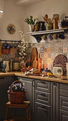 a kitchen filled with lots of clutter and cooking utensils on the counter