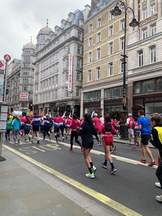 a large group of people running down the street