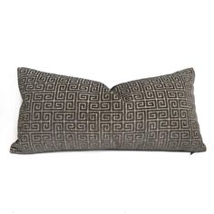 a black and white pillow on a white background