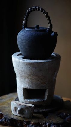 a tea pot sitting on top of a wooden table