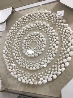 there are many white rocks arranged in a spiral