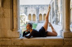 a woman laying on the ground with her legs crossed