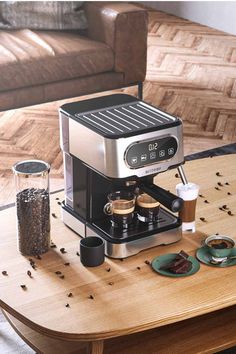 an espresso machine sitting on top of a wooden table