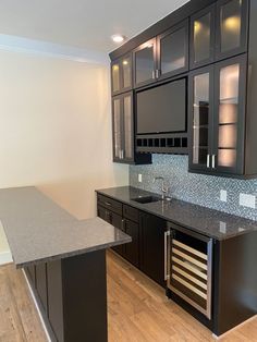 an empty kitchen with granite counter tops and stainless steel appliance on the island