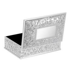 an ornate silver box with a mirror in it