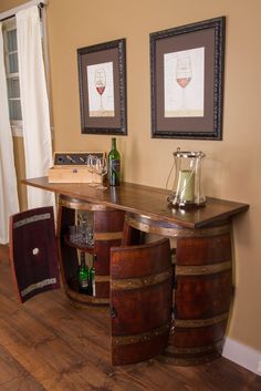 an old barrel turned into a bar with wine glasses on top