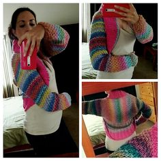 a woman taking a selfie in front of a mirror while wearing a colorful sweater