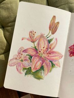 an open book with watercolor flowers on it