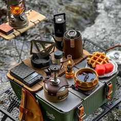 an outdoor picnic table with food and drinks on it, along with other items from around the world