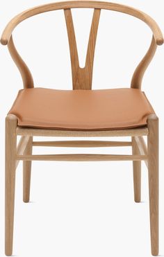 a wooden chair with tan leather upholstered on the seat and armrests