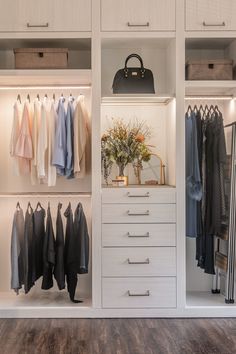 an organized closet with white cabinets and drawers