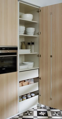 an open cabinet in a kitchen filled with food