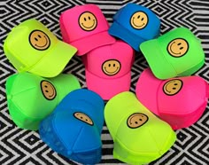 several hats with smiley faces are arranged in a circle