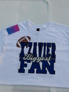 a white t - shirt with the words zavier biggest fan on it and a football