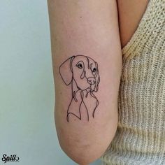 a woman's arm with a dog tattoo on the left side of her arm