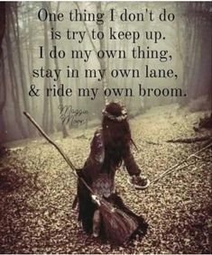 a woman in a witch costume holding a broom and walking through the woods with a quote on it