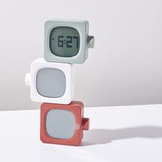 an alarm clock sitting on top of each other