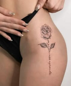 a woman's thigh with a rose tattoo on it