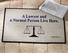 a door mat with the words'a lawyer and a normal person live here '