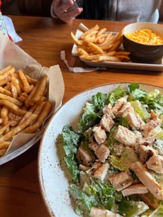 a salad and french fries on a table