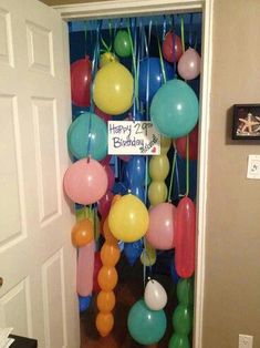 balloons and streamers are hanging from the door