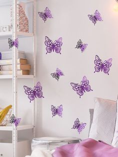 a bedroom with purple butterflies on the wall and white shelve in the corner