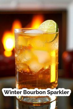 a close up of a drink in a glass with ice and lemon on the rim