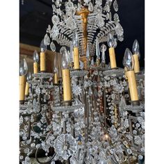 a chandelier with lots of crystal beads hanging from it's centerpiece