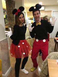 a man and woman dressed up as mickey and minnie mouse