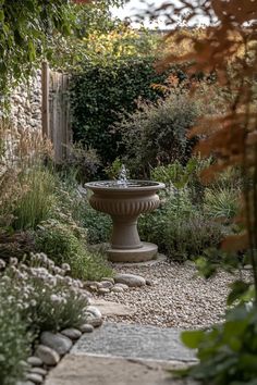 a stone fountain in the middle of a garden