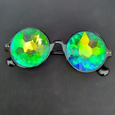 Black Kaleidoscope Sunglasses For Festivals And Raves. Real Glass Crystal Lenses Provide The Most Perfect, Psychedelic Incredible Kaleidoscope Effect Style: Modern Hippy Condition: New, Never Worn. Rave Festival Sunglasses With Tinted Lenses, Rave Style Festival Sunglasses With Tinted Lenses, Rave Party Sunglasses With Mirrored Lenses, Rave Festival Sunglasses With Mirrored Lenses, Rave Sunglasses With Mirrored Lenses And Adjustable Fit, Multicolor Glass Sunglasses For Festivals, Rave Sunglasses With Gradient Lenses For Party, Black Retro Sunglasses For Festival, Retro Black Sunglasses For Festival