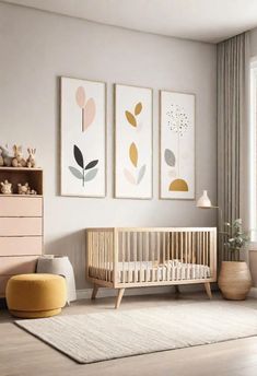 a baby's room with three paintings on the wall and a crib in the foreground