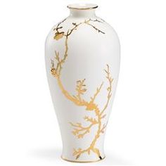 a white vase with gold designs on it