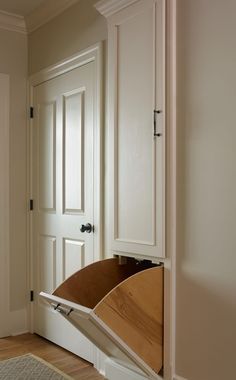 an open cabinet with a wooden paddle in it's bottom compartment on the door