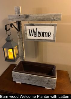 a welcome sign and lantern on a table