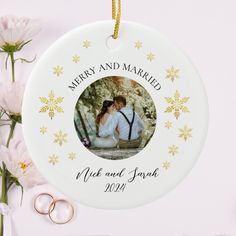 a personalized ornament for a newly married couple with their wedding rings and flowers