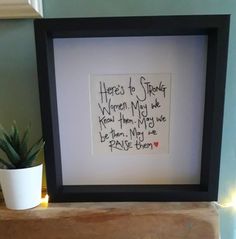 there is a framed picture with writing on it