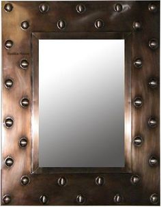 a square mirror with metal rivets on it