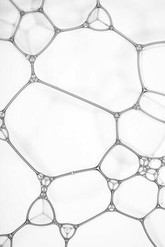 a close up view of some kind of wire mesh fence with drops of water on it