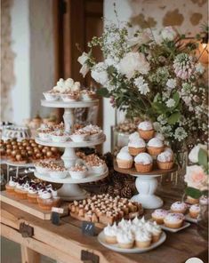 a table topped with lots of cupcakes and cakes